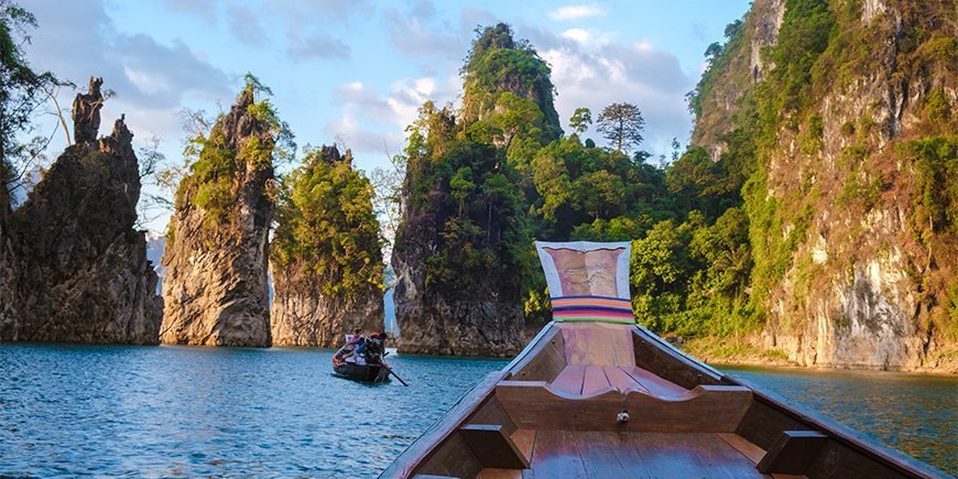 Båt seglar på sjön i Khao Sok National Park